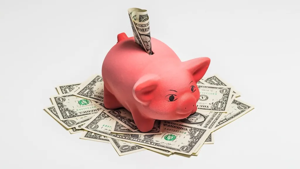 A savings jar and coins, representing a household reserve built for long-term goals